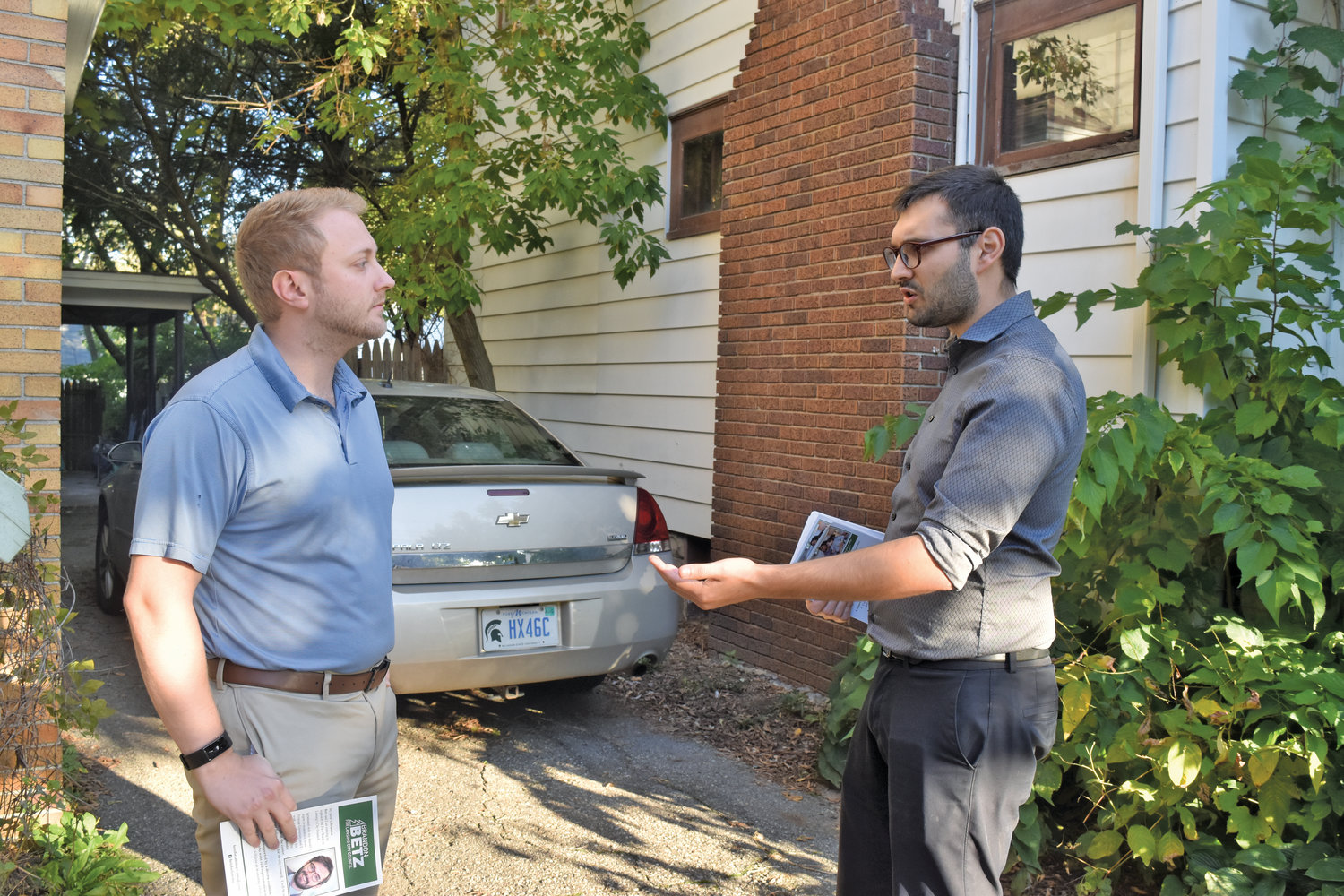 Councilman Brandon Betz (right) talks to a voter on the campaign trail.